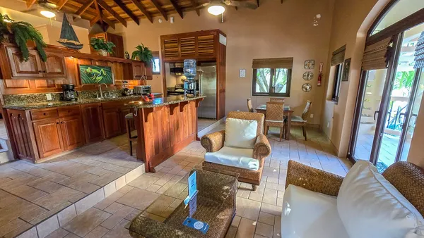 a living room with furniture a dining table and wooden floor