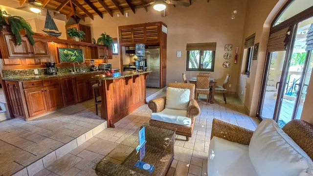 a living room with furniture a dining table and wooden floor