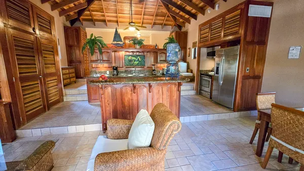 a view of a patio with dining table and chairs