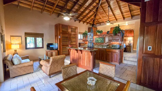 a living room with furniture and a kitchen view
