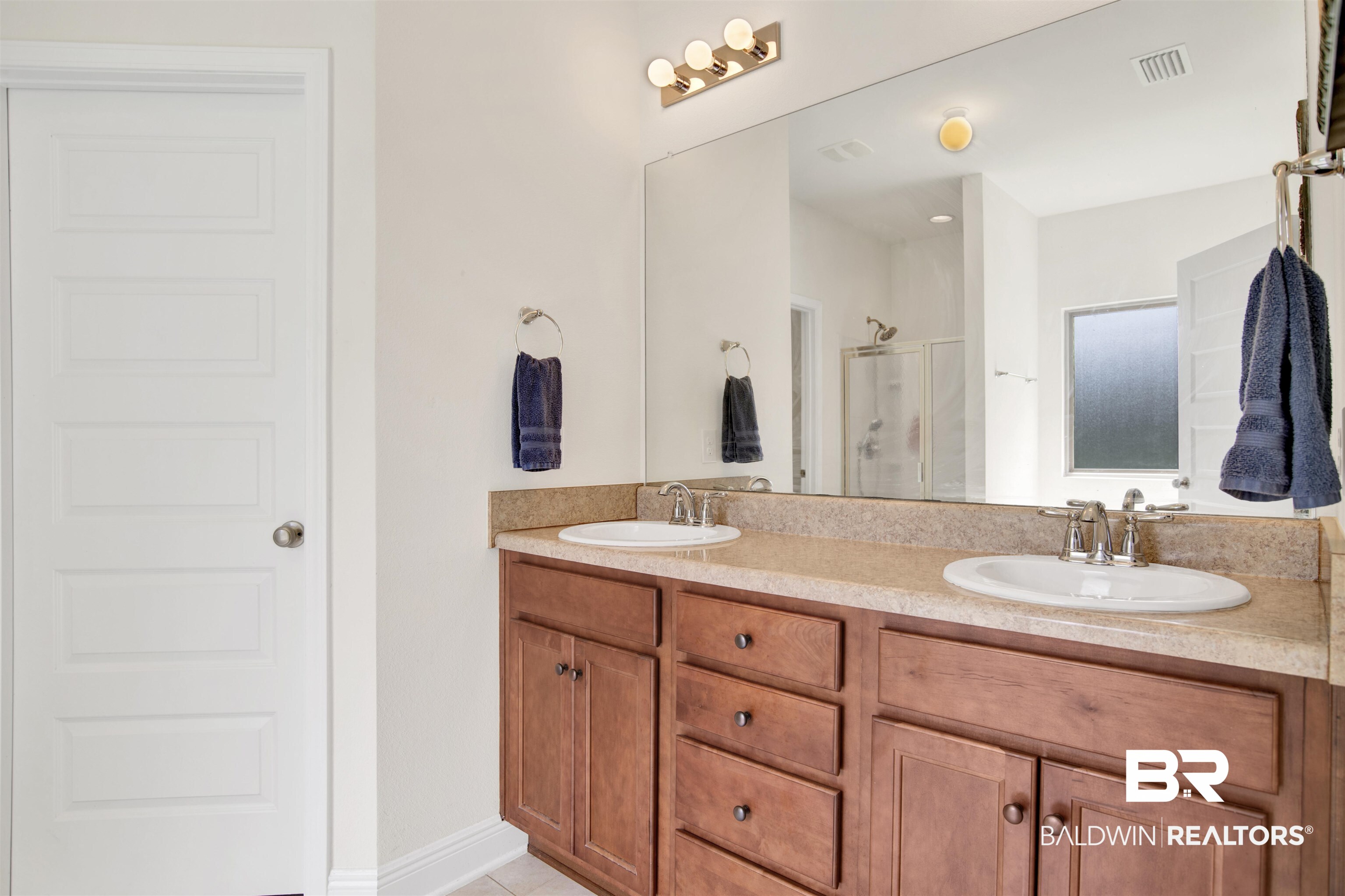 1468 Surrey Loop Foley, AL 36535 - Photo 23 of 28 Full bathroom with a shower stall, double vanity, and tile patterned flooring
