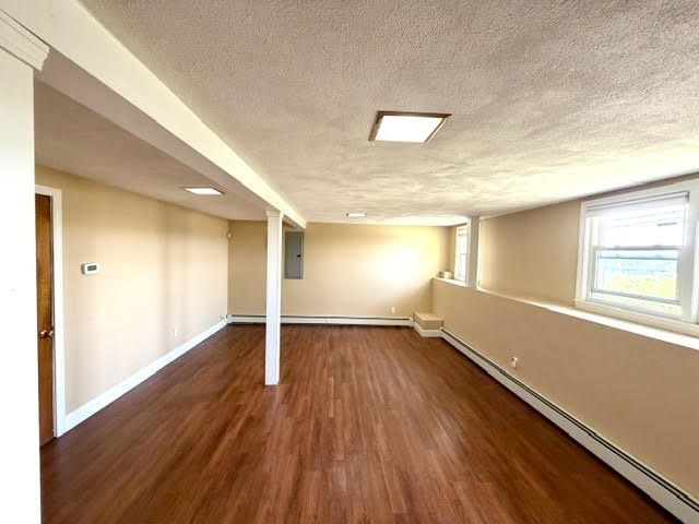 116 Upton Road Waltham, MA 02452 - Photo 17 of 22 a view of an empty room with wooden floor and a window