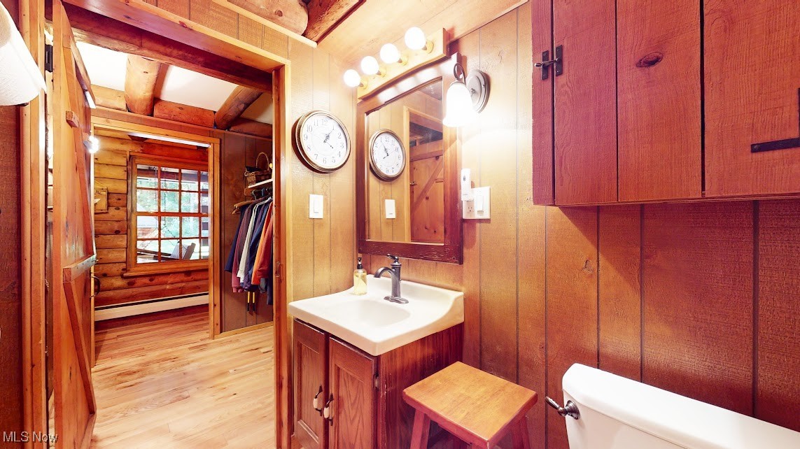 9471 Sherman Road Chesterland, OH 44026 - Photo 24 of 40 Bathroom with vanity, light wood finished floors, baseboard heating, beam ceiling