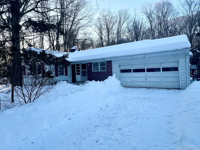 a view of a house with a yard and garage
