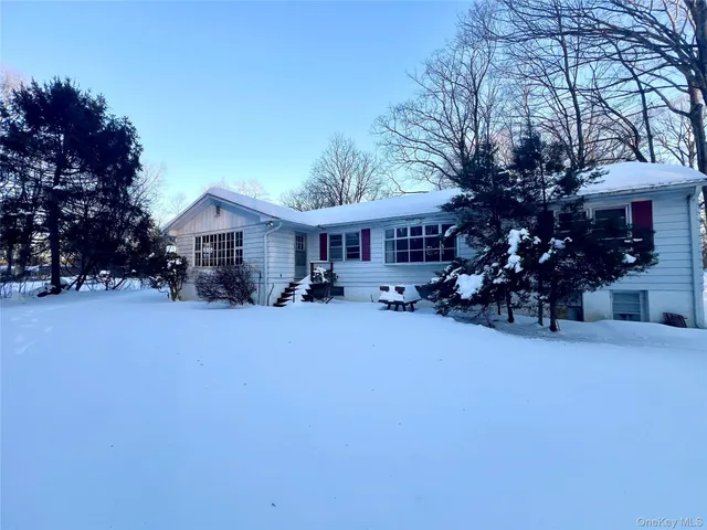 a view of a house with a yard and tree s