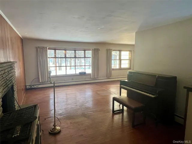 a room with windows and wooden floor