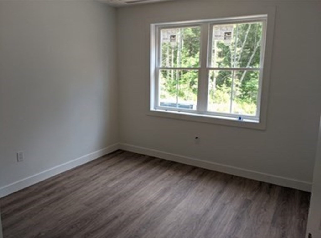 514 Old County Road Holland, MA 01521 - Photo 19 of 40 an empty room with wooden floor and windows