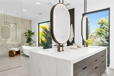 a bathroom with a double vanity sink and a mirror