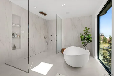 a bathroom with a tub and shower