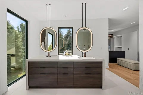 a bathroom with a double vanity sink and a mirror