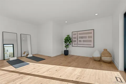 a living room with stainless steel appliances kitchen island furniture and a flat screen tv