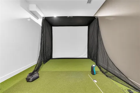 a view of a hallway with wooden floor and a bathroom