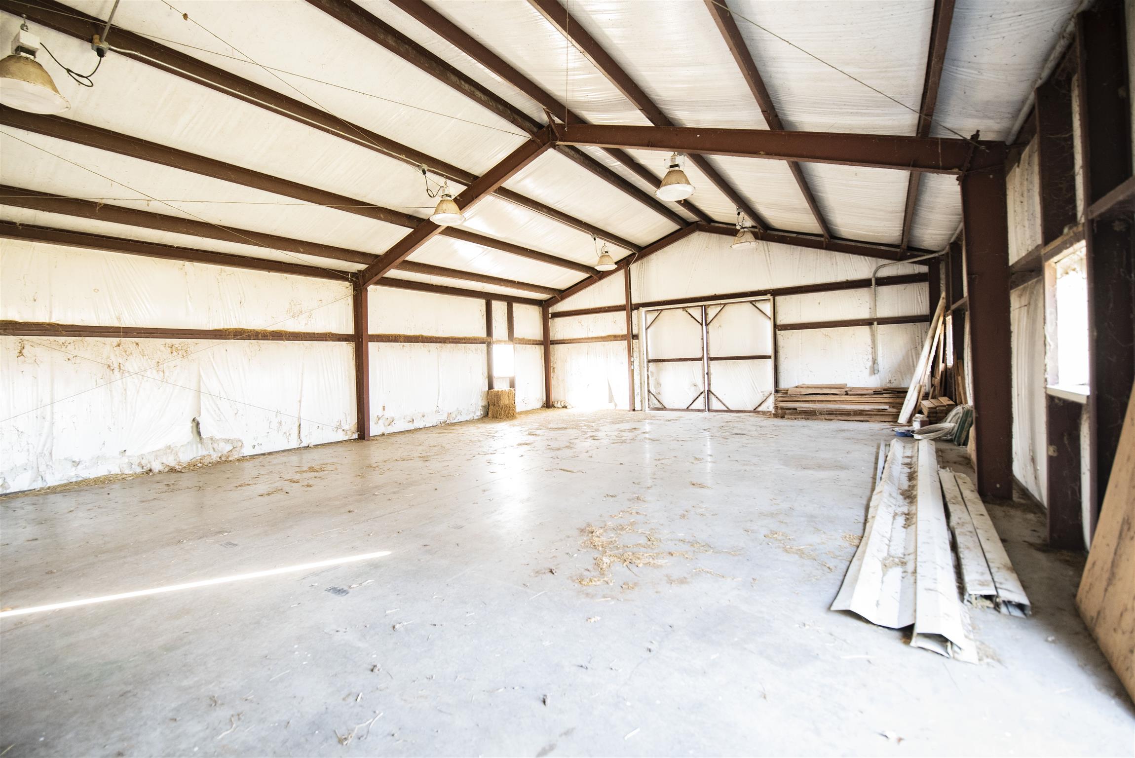 4936 Sledge Road Christiana, TN 37037 - Photo 4 of 30 Inside steel building with polished concrete floors, insulated and double sliding doors at both ends.