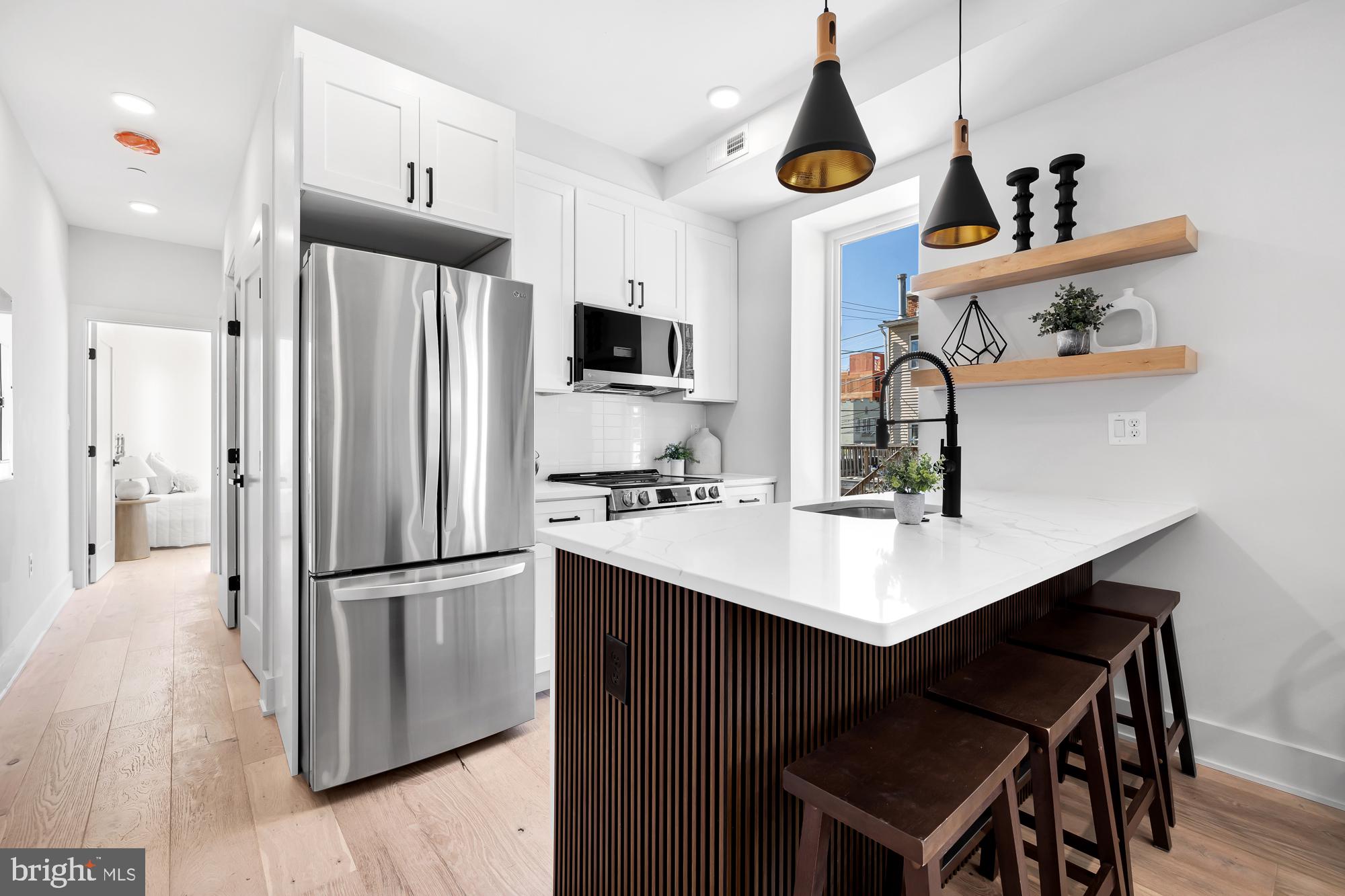 a kitchen with stainless steel appliances a sink a refrigerator and a stove