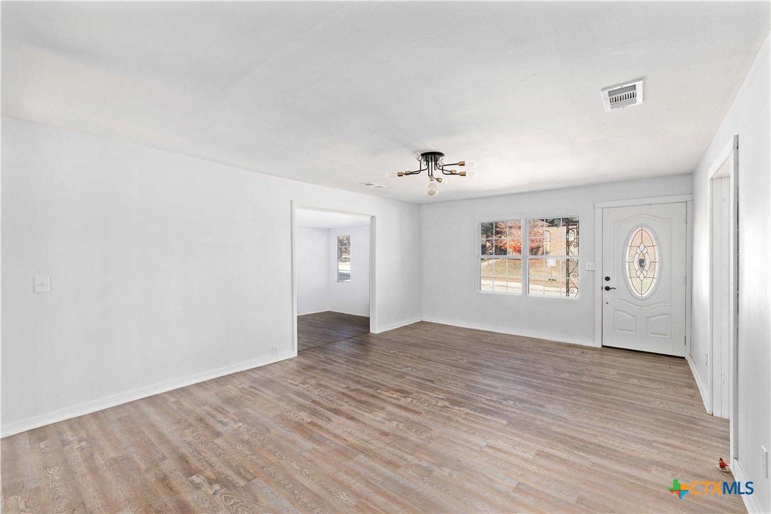 104 East Whitney Street Hamilton, TX 76531 - Photo 17 of 24 a view of empty room with wooden floor