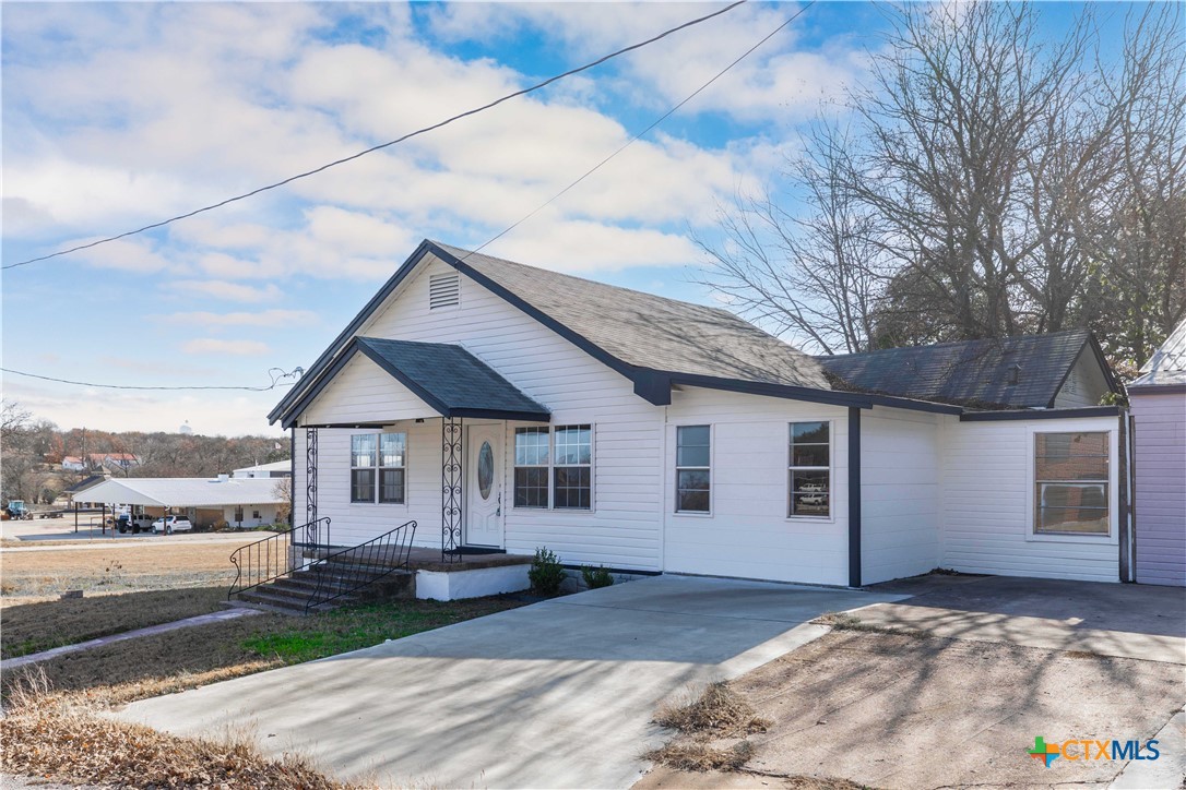 104 East Whitney Street Hamilton, TX 76531 - Photo 18 of 24 a front view of a house with garden