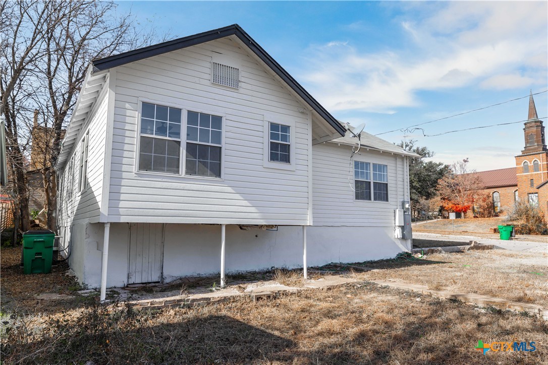 104 East Whitney Street Hamilton, TX 76531 - Photo 20 of 24 a view of a house with a yard