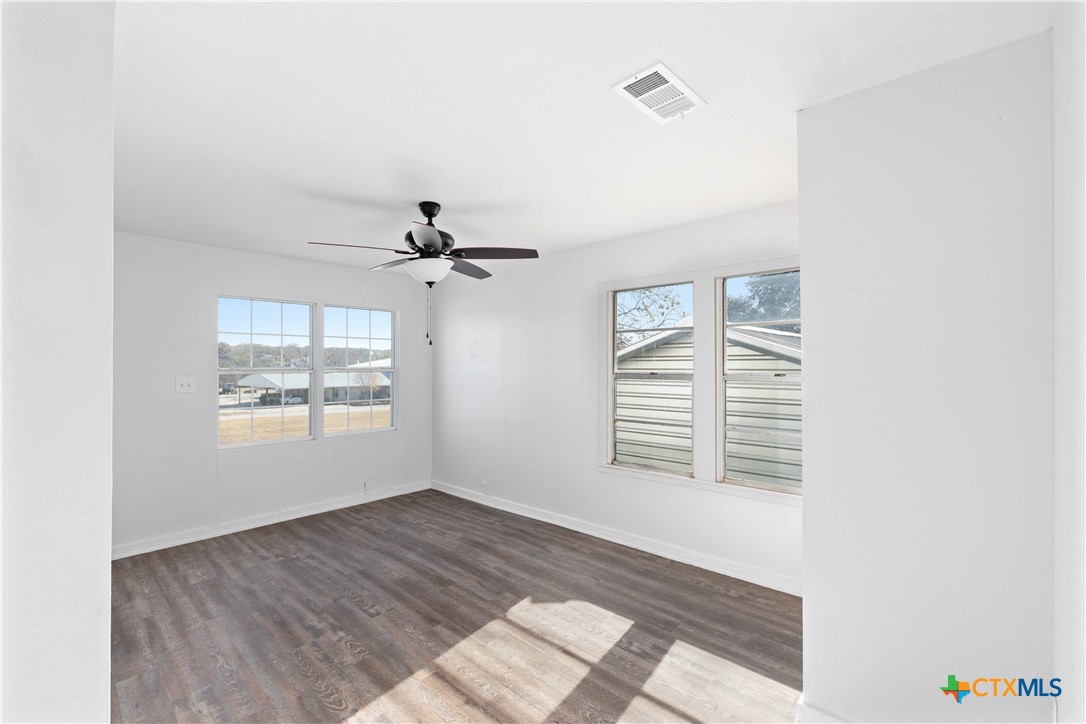 104 East Whitney Street Hamilton, TX 76531 - Photo 4 of 24 a view of an empty room with a window