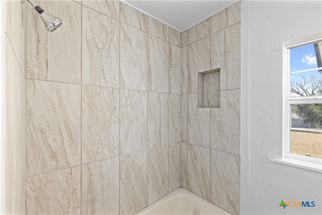 104 East Whitney Street Hamilton, TX 76531 - Photo 7 of 24 a bathroom with a shower curtain