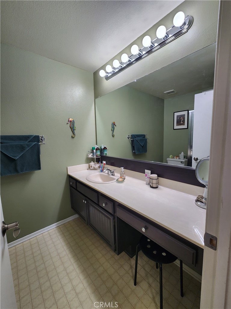 20334 Rue Crevier, Unit 622 Canyon Country, CA 91351 - Photo 12 of 22 a bathroom with a double vanity sink and a mirror
