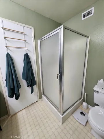 a spacious bedroom with a bed and ceiling fan