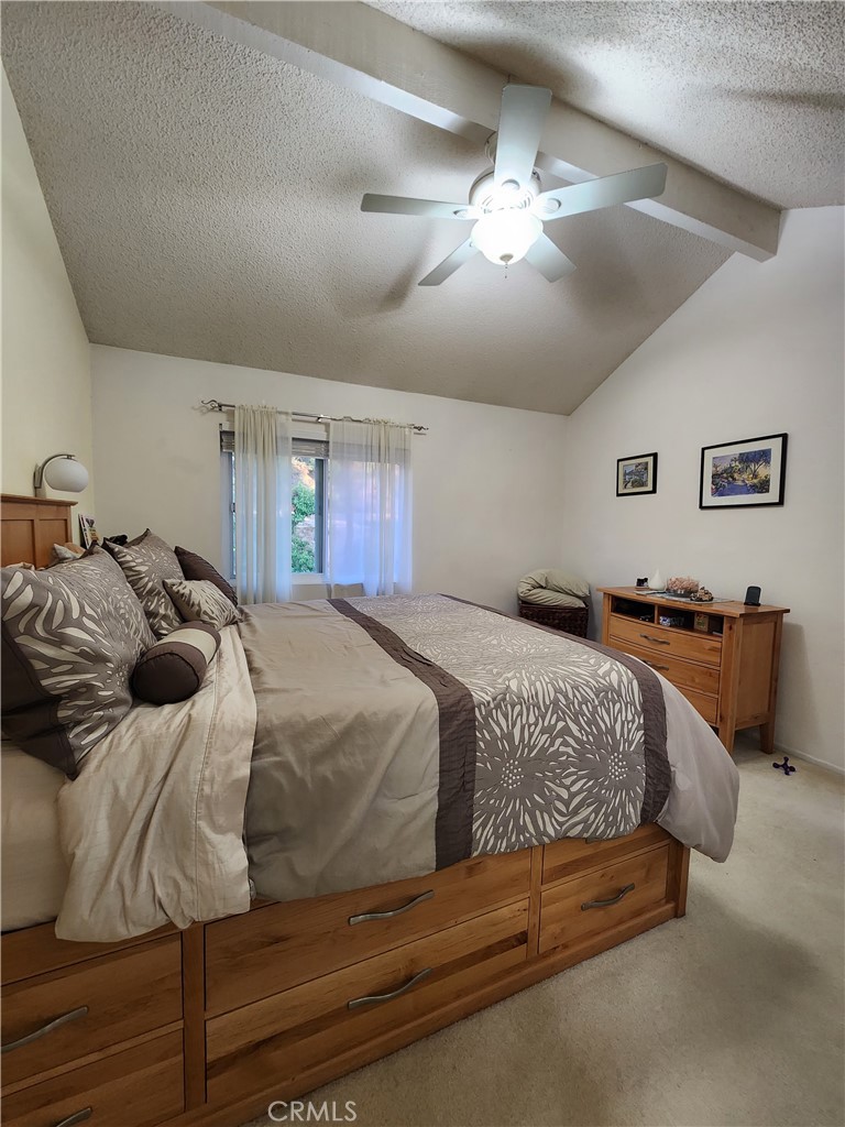 20334 Rue Crevier, Unit 622 Canyon Country, CA 91351 - Photo 14 of 22 a spacious bedroom with a bed and ceiling fan