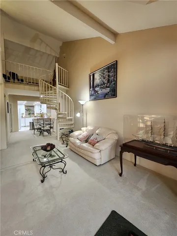 a living room with furniture and a piano