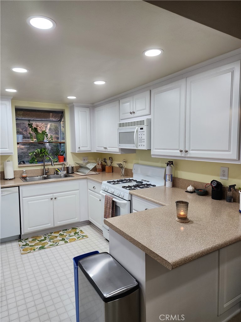 20334 Rue Crevier, Unit 622 Canyon Country, CA 91351 - Photo 3 of 22 a kitchen with a sink a stove cabinets and counter space