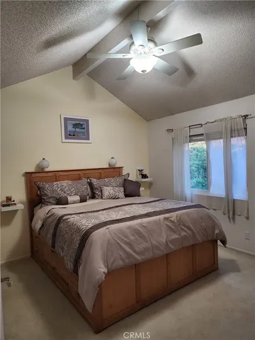 a bedroom with bed and a chandelier