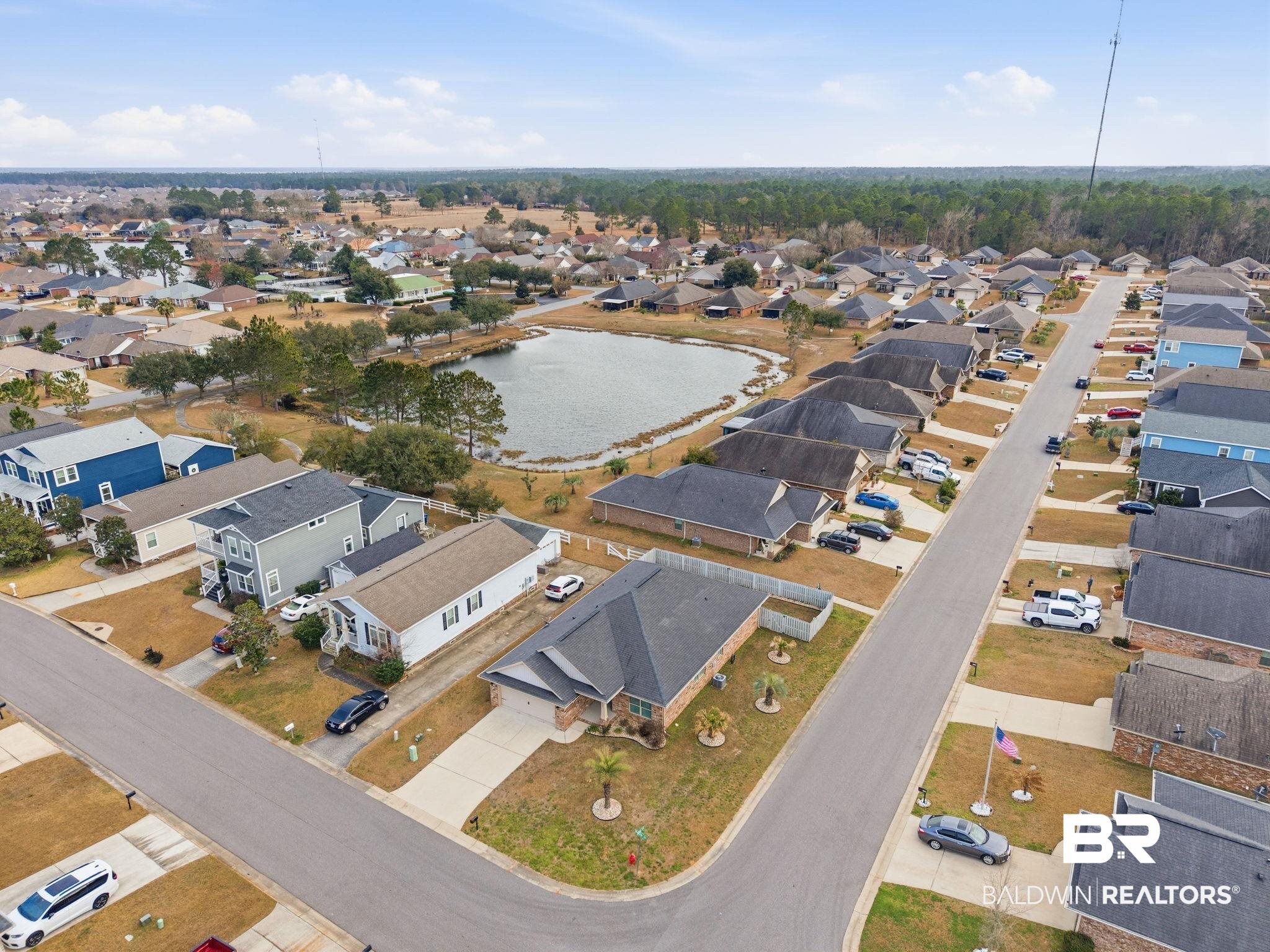 22596 Respite Lane Foley, AL 36535 - Photo 31 of 34 Aerial view of property and surrounding area featuring nearby suburban area and a nearby body of water