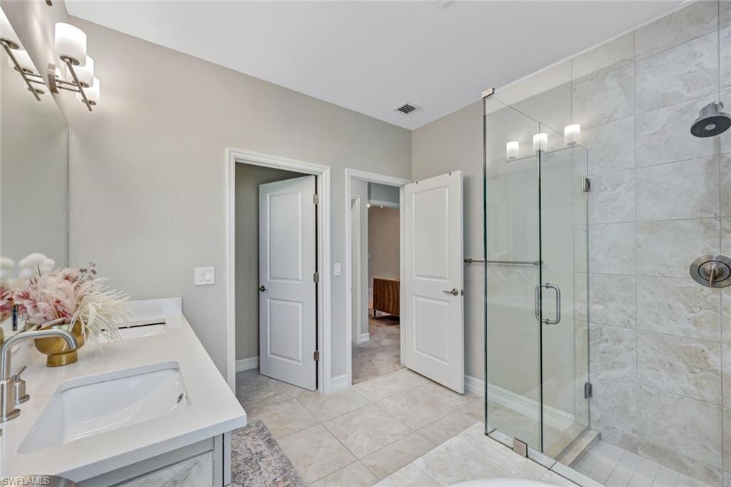 7348 Rockefeller Drive Naples, FL 34119 - Photo 19 of 39 Master Bathroom - Features a Walk-In Closet
