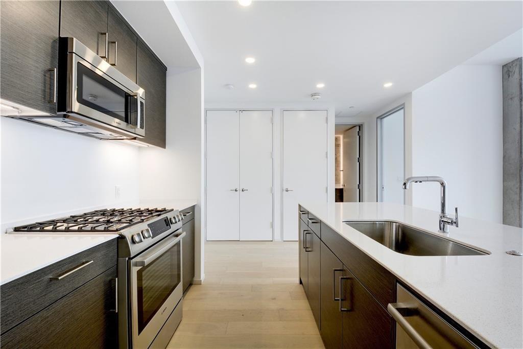 301 West Avenue, Unit 1202 Austin, TX 78701 - Photo 3 of 27 a kitchen with stainless steel appliances granite countertop a sink and a stove