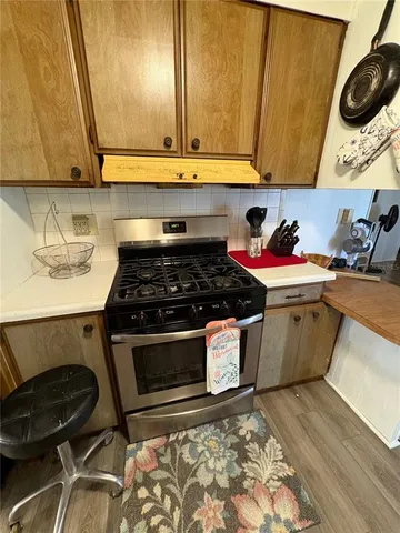 a kitchen with a stove and a microwave