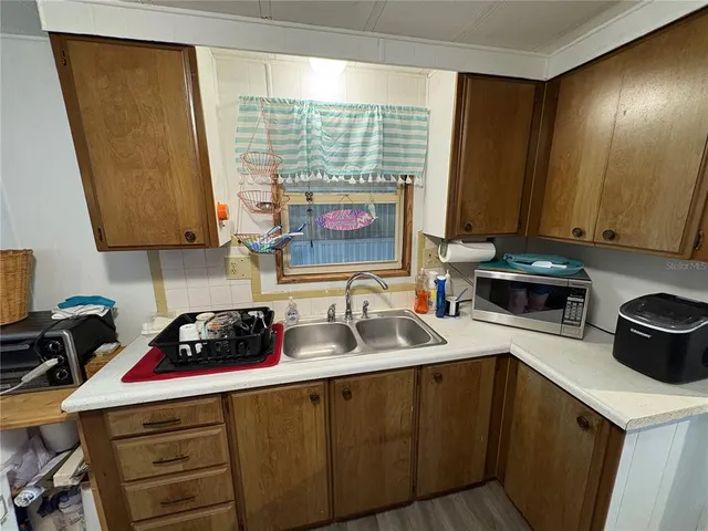 a kitchen with a sink a stove and cabinets