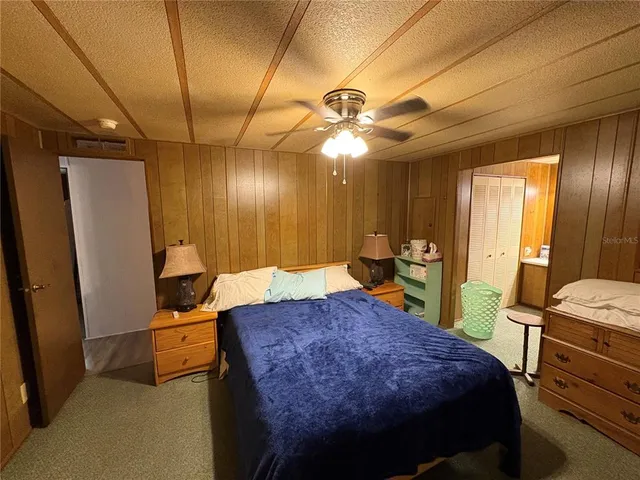 a bed room with a bed and a chandelier