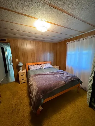 a bed sitting in a room next to a window