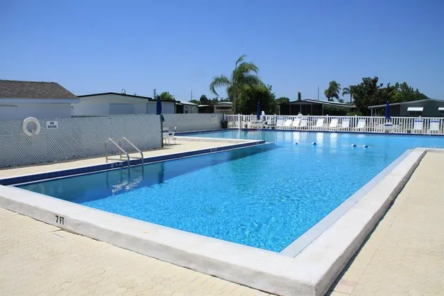 a view of swimming pool with outdoor seating
