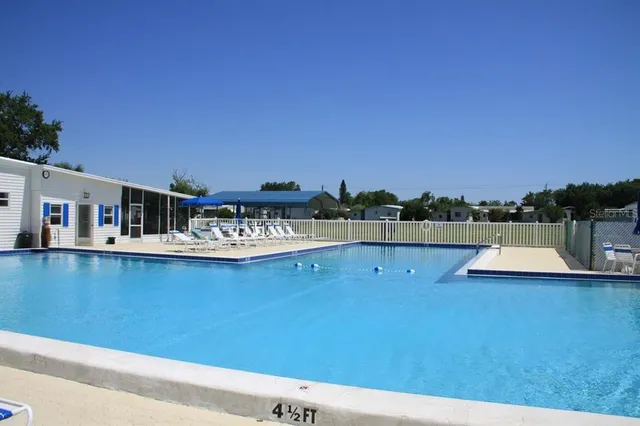 a view of a swimming pool with an outdoor seating and a garden