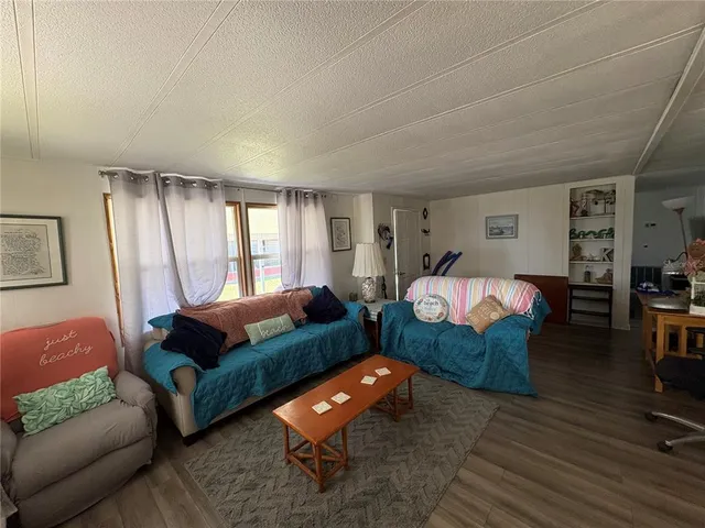 a bedroom with furniture and a large window