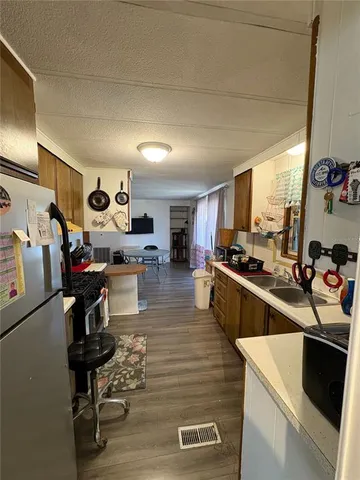 a kitchen with a sink appliances and cabinets