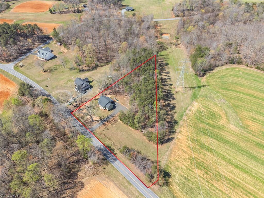 626 Bethany Road Reidsville, NC 27320 - Photo 35 of 42 Aerial view with lot lines at 626 Bethany Road, Reidsville, NC 27320, Rockingham County. Wider angle showing property boundary, Bethany Road, neighboring homes, and surrounding community. Bethany Community.