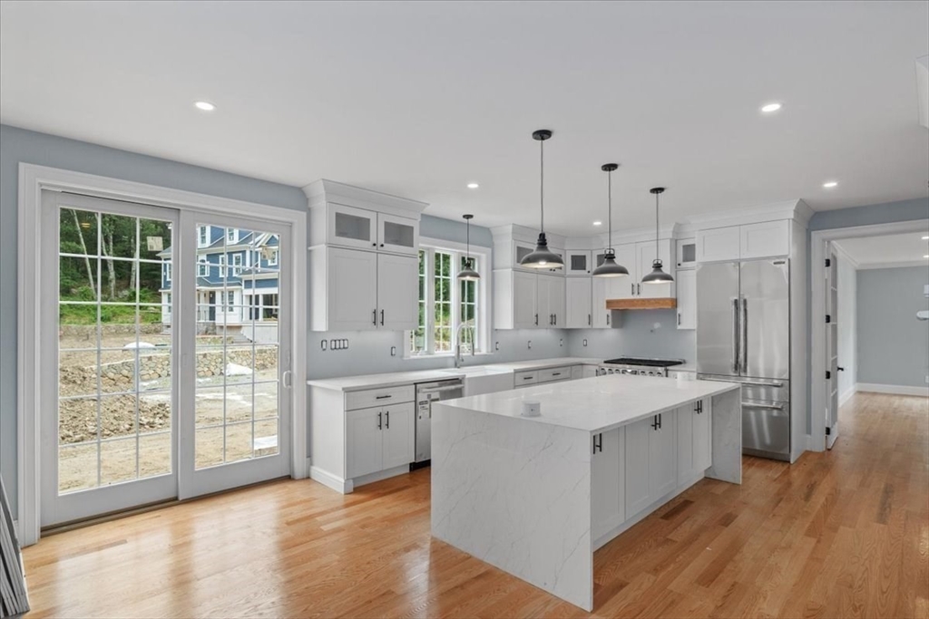 35 Shuttleworth Dedham, MA 02026 - Photo 5 of 28 a large kitchen with stainless steel appliances kitchen island a large counter top and a wooden floors