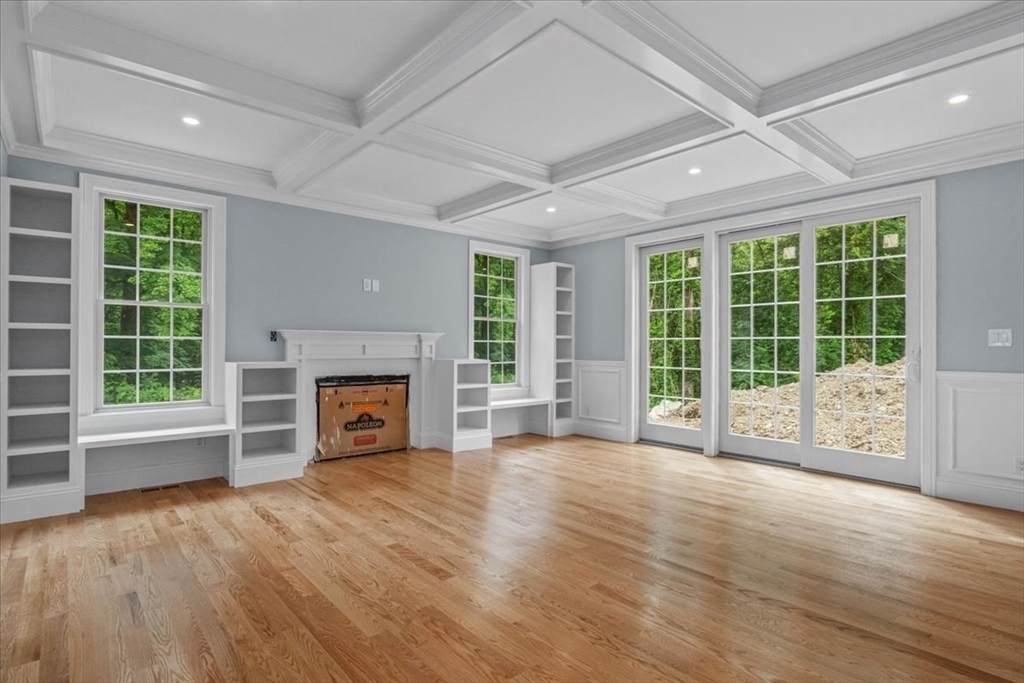 35 Shuttleworth Dedham, MA 02026 - Photo 9 of 28 a view of an empty room with wooden floor and a fireplace