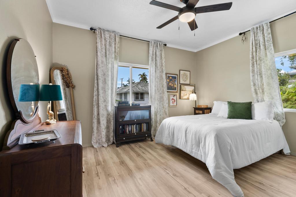 20 Alae Street Hilo, HI 96720 - Photo 12 of 30 a bedroom with a bed and wooden floor