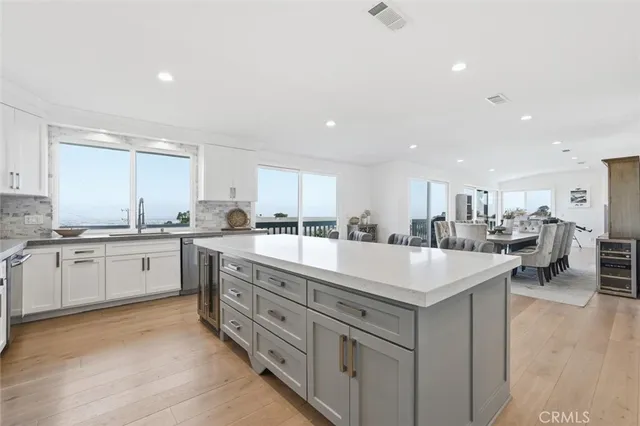 a dining room with furniture and a floor to ceiling window