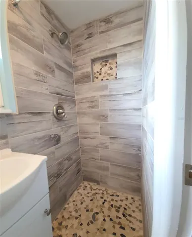 a bathroom with a shower and a sink