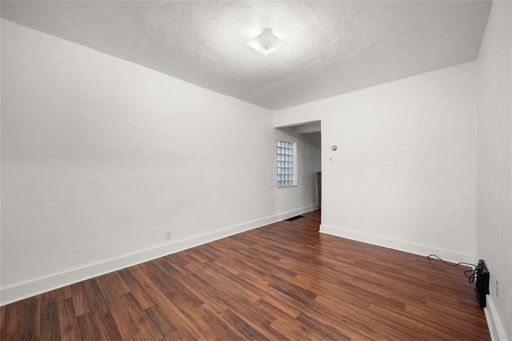 1128 9th Street McKees Rocks, PA 15136 - Photo 12 of 33 a view of an empty room with wooden floor
