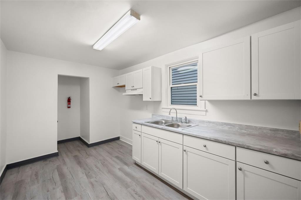 1128 9th Street McKees Rocks, PA 15136 - Photo 13 of 33 a kitchen with a sink a window and cabinets