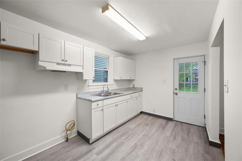 1128 9th Street McKees Rocks, PA 15136 - Photo 14 of 33 a kitchen with granite countertop a stove and a sink