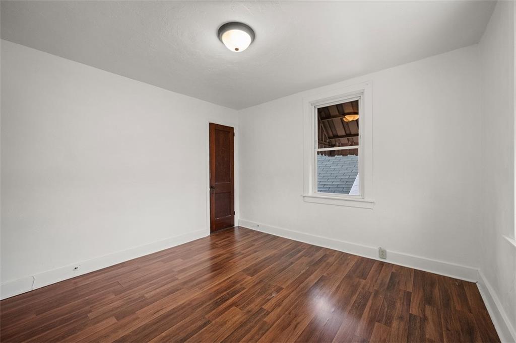 1128 9th Street McKees Rocks, PA 15136 - Photo 20 of 33 an empty room with wooden floor and windows